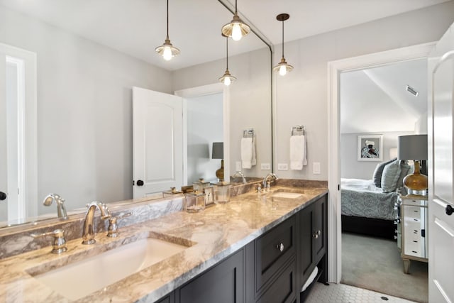 ensuite bathroom with double vanity, a sink, visible vents, and ensuite bath