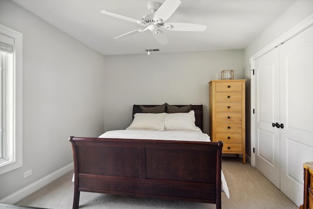 bedroom with visible vents, multiple windows, and light colored carpet
