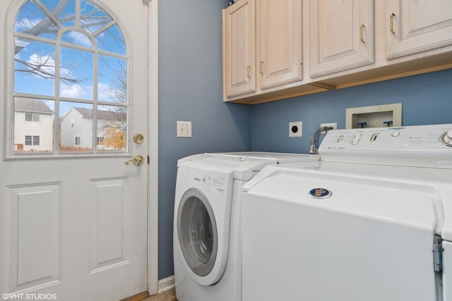 laundry room with cabinet space and separate washer and dryer
