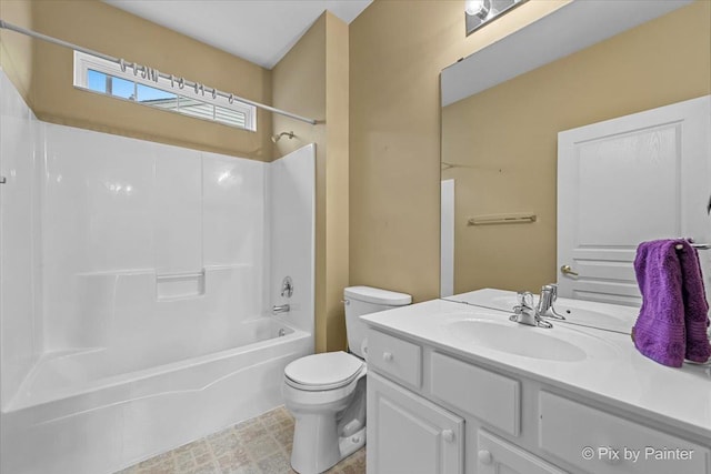 bathroom featuring toilet, vanity, and  shower combination