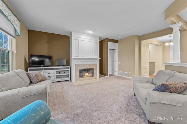 living room with baseboards, an inviting chandelier, light carpet, visible vents, and a premium fireplace