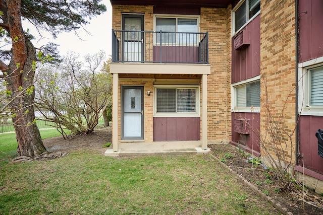 212A Collen Dr Unit 104, Lombard, IL 60148 - property entrance featuring brick siding, a lawn, and a balcony