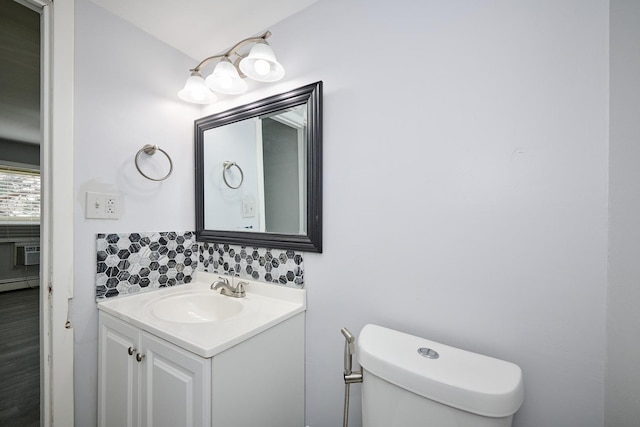 212A Collen Dr Unit 104, Lombard, IL 60148 - half bath with tasteful backsplash, toilet, vanity, and a baseboard heating unit