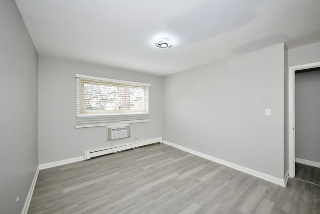 212A Collen Dr Unit 104, Lombard, IL 60148 - spare room featuring a wall mounted AC, a baseboard heating unit, baseboards, and wood finished floors