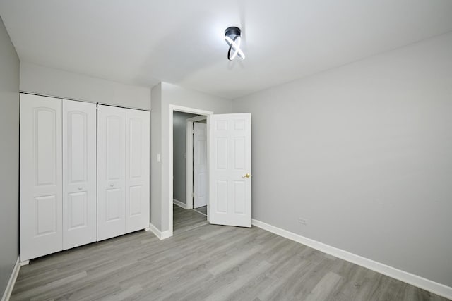 212A Collen Dr Unit 104, Lombard, IL 60148 - unfurnished bedroom with a closet, baseboards, and wood finished floors