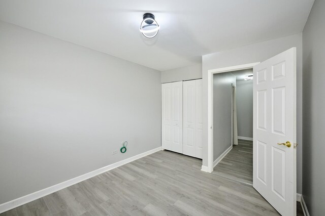 212A Collen Dr Unit 104, Lombard, IL 60148 - unfurnished bedroom featuring a closet, baseboards, and light wood-style floors