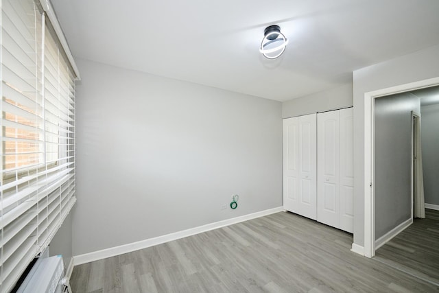 212A Collen Dr Unit 104, Lombard, IL 60148 - unfurnished bedroom with a closet, baseboards, and wood finished floors