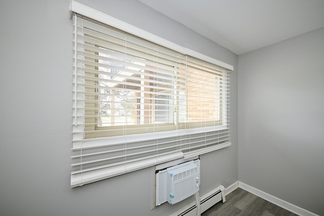 212A Collen Dr Unit 104, Lombard, IL 60148 - room details featuring an AC wall unit, baseboards, and wood finished floors