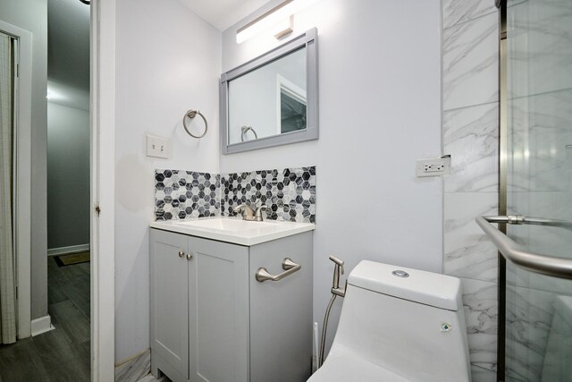212A Collen Dr Unit 104, Lombard, IL 60148 - bathroom featuring backsplash, toilet, vanity, and wood finished floors