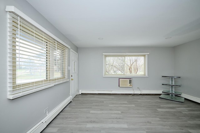 212A Collen Dr Unit 104, Lombard, IL 60148 - unfurnished room with baseboards, a baseboard heating unit, a wall unit AC, and wood finished floors