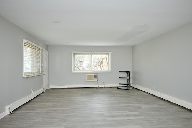 212A Collen Dr Unit 104, Lombard, IL 60148 - empty room featuring an AC wall unit, a baseboard heating unit, baseboards, and wood finished floors