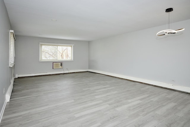 212A Collen Dr Unit 104, Lombard, IL 60148 - spare room with a wall mounted AC, wood finished floors, baseboards, and a baseboard heating unit