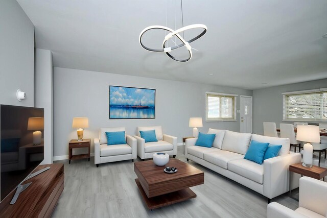 212A Collen Dr Unit 104, Lombard, IL 60148 - living area featuring baseboards, light wood finished floors, a chandelier, and a healthy amount of sunlight