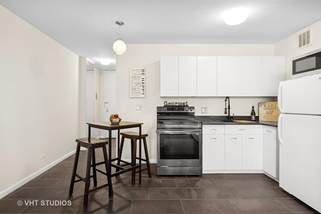 2400 N Lakeview Ave Unit 901, Chicago, IL 60614 - kitchen with appliances with stainless steel finishes, a sink, white cabinets, and dark countertops