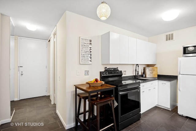 2400 N Lakeview Ave Unit 901, Chicago, IL 60614 - kitchen featuring stainless steel microwave, freestanding refrigerator, visible vents, black range with electric stovetop, and a sink