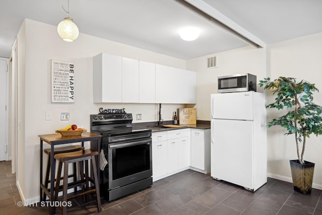 2400 N Lakeview Ave Unit 901, Chicago, IL 60614 - kitchen with dark countertops, white cabinets, appliances with stainless steel finishes, and a sink