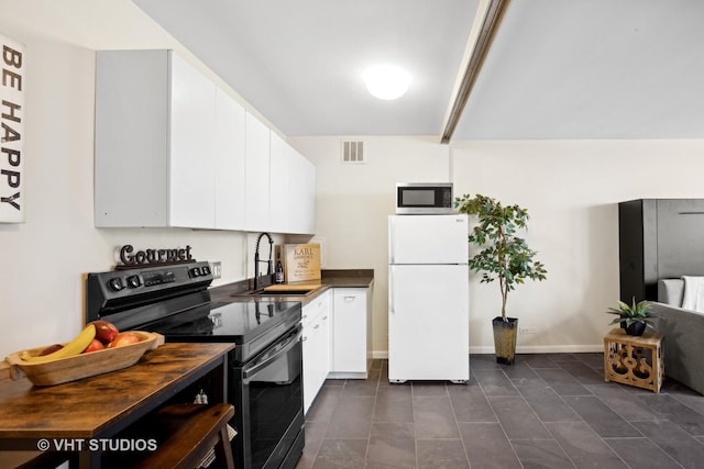 2400 N Lakeview Ave Unit 901, Chicago, IL 60614 - kitchen featuring stainless steel microwave, electric range, freestanding refrigerator, visible vents, and a sink