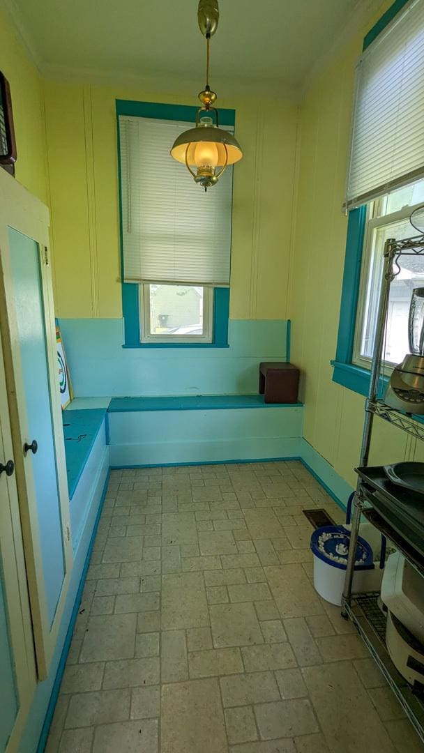 245 N Main St, Cisco, IL 61830 - kitchen featuring a decorative wall, brick floor, and pendant lighting