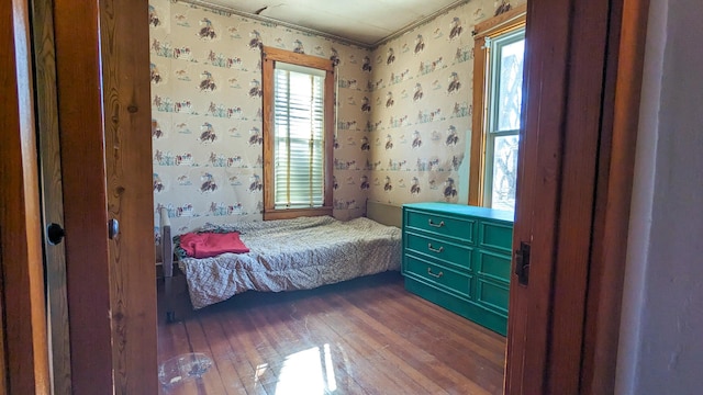 245 N Main St, Cisco, IL 61830 - bedroom with wallpapered walls and dark wood finished floors