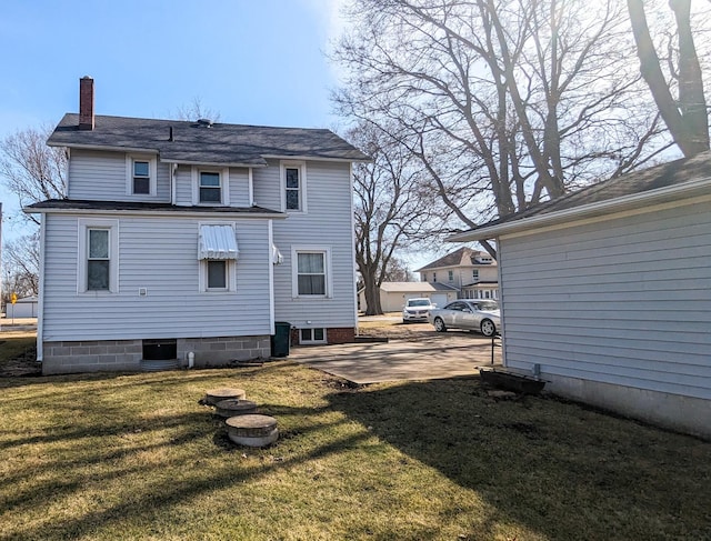 245 N Main St, Cisco, IL 61830 - back of house with a chimney, a patio area, and a yard