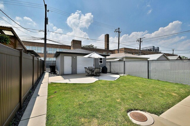 5628 S Merrimac Ave, Chicago, IL 60638 - back of property with a fenced backyard, a patio area, and an outbuilding