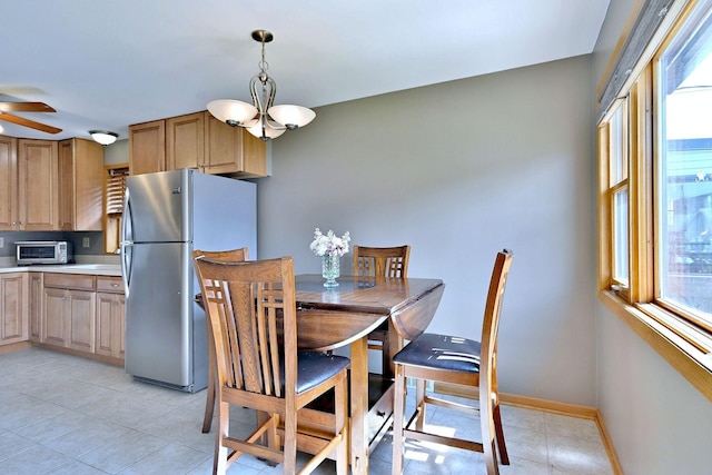 5628 S Merrimac Ave, Chicago, IL 60638 - dining area with plenty of natural light, a ceiling fan, a chandelier, and light tile patterned floors
