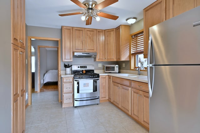 5628 S Merrimac Ave, Chicago, IL 60638 - kitchen with appliances with stainless steel finishes, under cabinet range hood, light countertops, ceiling fan, and light tile patterned floors