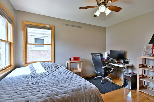 5628 S Merrimac Ave, Chicago, IL 60638 - bedroom featuring multiple windows, wood finished floors, and a desk