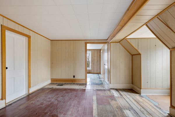 bonus room featuring wooden walls, baseboards, and hardwood / wood-style flooring