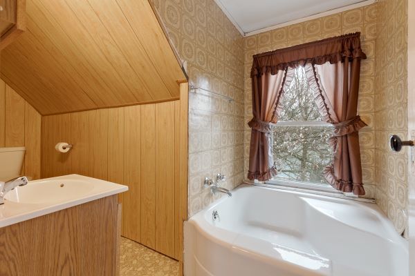 bathroom featuring vanity and a bath