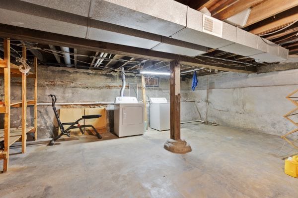 unfinished below grade area featuring visible vents and washing machine and dryer
