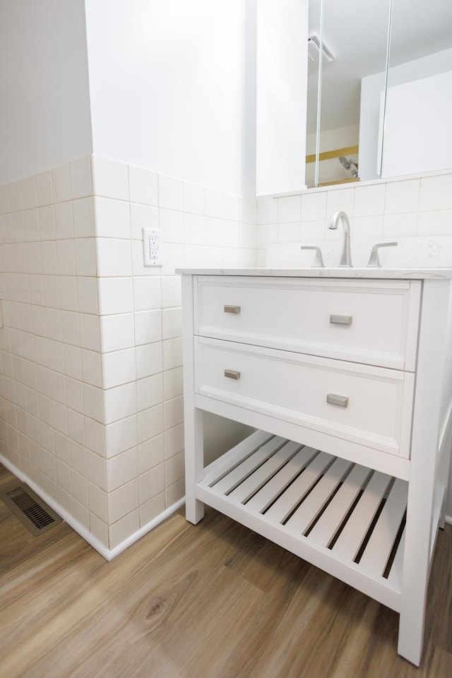 13 Park Pl, Kankakee, IL 60901 - bathroom featuring vanity, visible vents, tile walls, and wood finished floors