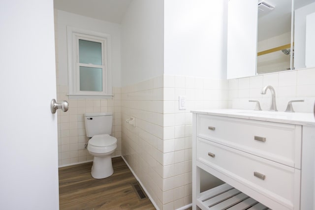 13 Park Pl, Kankakee, IL 60901 - bathroom with vanity, toilet, visible vents, tile walls, and wood finished floors