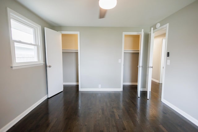 13 Park Pl, Kankakee, IL 60901 - unfurnished bedroom with baseboards, two closets, and dark wood-style floors