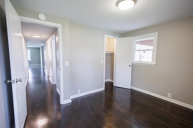 13 Park Pl, Kankakee, IL 60901 - unfurnished bedroom featuring a closet, baseboards, and dark wood-style floors