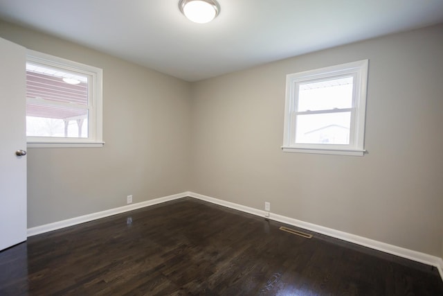 13 Park Pl, Kankakee, IL 60901 - unfurnished room featuring visible vents, baseboards, and dark wood-style floors