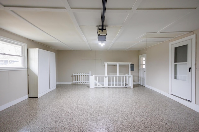13 Park Pl, Kankakee, IL 60901 - garage featuring baseboards and a garage door opener
