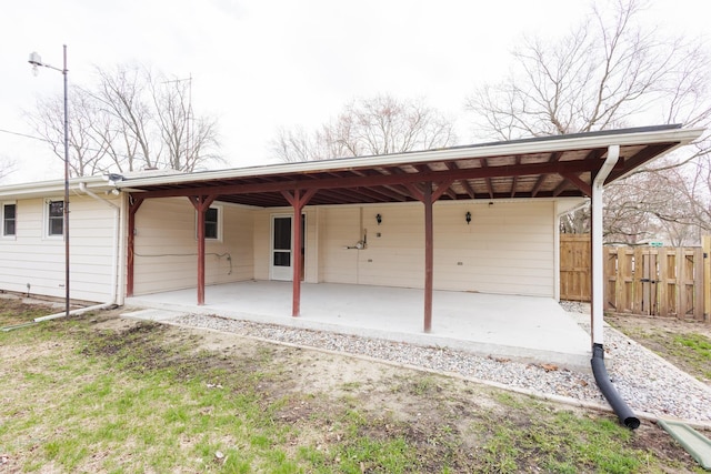 13 Park Pl, Kankakee, IL 60901 - rear view of house featuring fence, a patio, and an attached carport