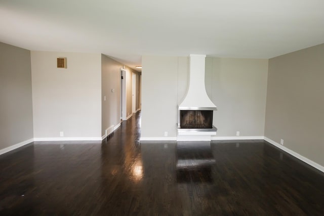 13 Park Pl, Kankakee, IL 60901 - unfurnished living room with dark wood-style floors, baseboards, and visible vents