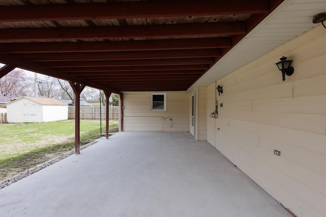 13 Park Pl, Kankakee, IL 60901 - view of patio / terrace featuring fence, an outdoor structure, an attached carport, and a shed