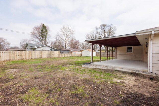 13 Park Pl, Kankakee, IL 60901 - view of yard featuring a storage shed, a patio, a fenced backyard, and an outdoor structure