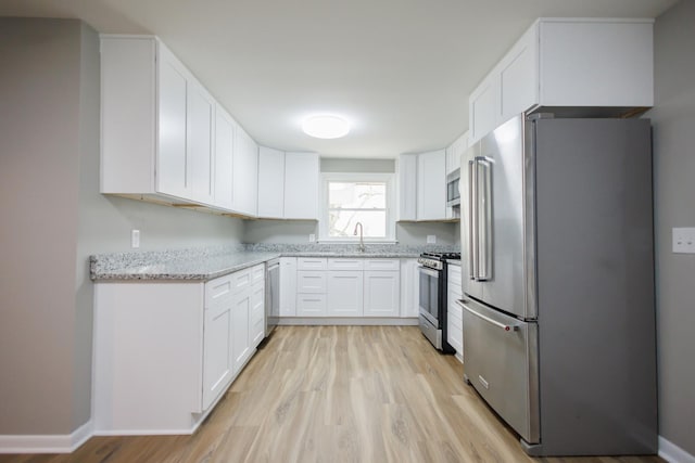 13 Park Pl, Kankakee, IL 60901 - kitchen featuring a sink, appliances with stainless steel finishes, and white cabinetry