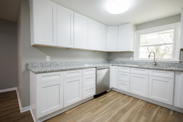 13 Park Pl, Kankakee, IL 60901 - kitchen with light stone countertops, light wood-style flooring, white cabinets, a sink, and baseboards