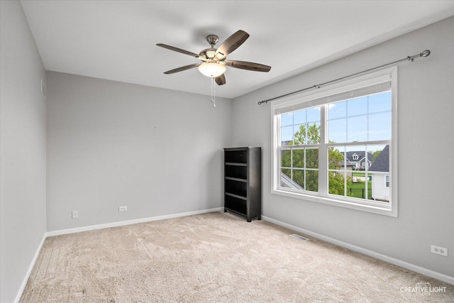 spare room featuring a ceiling fan, baseboards, and carpet flooring