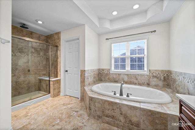bathroom with a bath, a stall shower, recessed lighting, and vanity