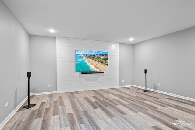 basement featuring wood finished floors, recessed lighting, and baseboards