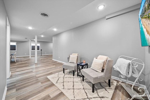 sitting room with wood finished floors, baseboards, and recessed lighting