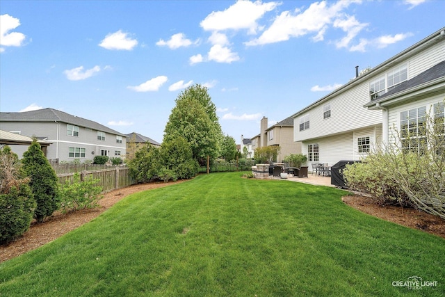 view of yard featuring a patio and a residential view