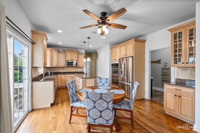 dining space featuring light wood-style floors, a ceiling fan, and recessed lighting