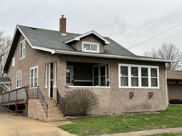 exterior space with stucco siding and a chimney